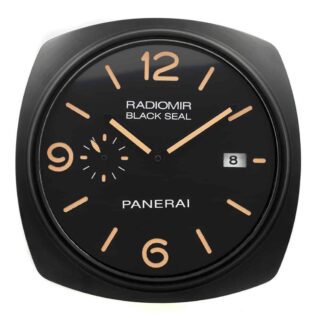 Panerai wall clock with a rounded square black frame, black dial, tan numerals, "RADIOMIR BLACK SEAL," "PANERAI" text, and date display at three o’clock.