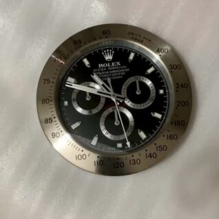 Close-up of a Rolex Oyster Perpetual Cosmograph watch face with black dial, three subdials, and silver bezel marked with units per hour scale from 60 to 400.